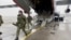 A still image from video released by Russia's Defence Ministry shows Russian service members disembarking from a military aircraft, at an airfield in Kazakhstan, Jan. 7, 2022. 