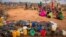 FILE - People wait for food and water in the Warder district in the Somali region of Ethiopia, Jan. 28, 2017.
