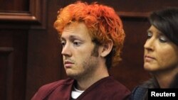 Colorado shooting suspect James Eagan Holmes (L) sits with public defender Tamara Brady during his first court appearance in Aurora, Colorado, July 23, 2012.