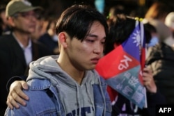 Supporters of Taiwan People's Party presidential candidate Ko Wen-je wait for results in the presidential election at the TPP headquarters in Xinzhuang in New Taipei City, Taiwan, Jan. 13, 2024.