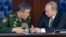 FILE - Russian President Vladimir Putin (r) speaks with Chief of the General Staff of the Russian Armed Forces Valery Gerasimov at a meeting with top military officials in the National Defense Control Center in Moscow, Dec. 11, 2015. 