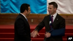 Acting Department of Homeland Security Secretary Kevin McAleenan, right, and Guatemalan President Jimmy Morales shake hands at the National Palace in Guatemala CIty, May 27, 2019.