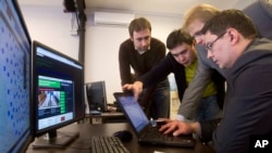 FILE - IT specialists set up a computer system at the "Elections 2012" situation center in Moscow, March 3, 2012.