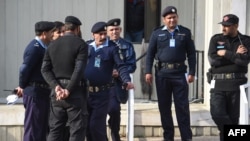 FILE - Pakistani policemen stand guard in front of the Supreme Court building during the court review appeal against a Pakistani Christian woman who spent eight years on death row for blasphemy, in Islamabad on Jan. 29, 2019.