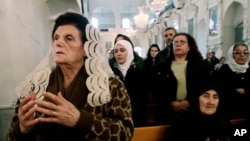 Syrian Christians and Muslims offer prayers for nuns held by rebels, at the Greek Orthodox Mariamiya Church in Damascus, Syria, Sunday, Dec. 8, 2013.