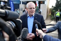 FILE - Australian Prime Minister Scott Morrison speaks to the media as he arrives at the Horizon Church in Sutherland in Sydney, Australia, May 19, 2019. (AAP Image/Joel Carrett/via Reuters)