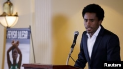 Rio Olympic marathon silver medalist Feyisa Lilesa of Ethiopia attends a news conference in Washington, Sept. 13, 2016. 
