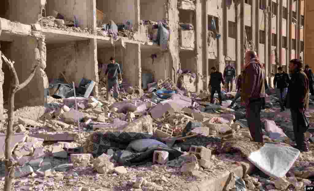 Syrians gather at the scene of an explosion outside Aleppo University, between the university dormitories and the architecture facility, January 15, 2013.
