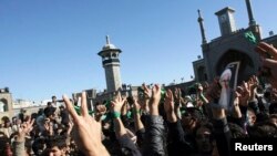 FILE - Supporters of the Iranian opposition movement wear green during the funeral of Grand Ayatollah Hossein Ali Montazeri in the holy city of Qom Dec. 21, 2009.