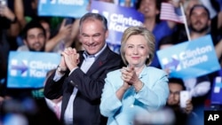 Democratic presidential candidate Hillary Clinton with Sen. Tim Kaine, D-Va., at a rally at Florida International University Panther Arena in Miami, July 23, 2016. 