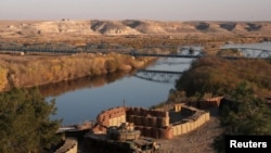 FILE - A Turkish army tank is positioned at a military post by the Euphrates river on the Turkish-Syrian border, in Karkamis, Gaziantep province, Turkey, Dec. 13, 2017. 