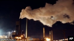 In this July 8, 2011 file photo, smoke bellows from a chimney stack at BlueScope Steel's mill at Port Kembla, south of Sydney, Australia.