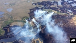 FILE - In this June 7, 2015 file photo, smoke rises from the Bogus Creek Fire, one of two fires burning in the Yukon Delta National Wildlife Refuge in southwest Alaska.