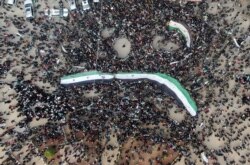 Protesters gather to mark the 10th anniversary of the start of the Syrian conflict, in opposition-held Idlib, Syria, March 15, 2021.