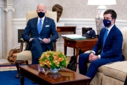 FILE - President Joe Biden and Transportation Secretary Pete Buttigieg are pictured at the White House in Washington, March 4, 2021. Buttigieg called the U.S. disparity with China in infrastructure investment "a threat to our collective future."