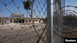 The Northeast gate marks the end of U.S. soil as the road leads into Cuba at Guantanamo Bay U.S. Naval Base, March 8, 2013. 