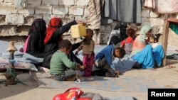 Internally displaced people sit at a makeshift camp for IDPs in al-Jarahi, south of the Red Sea port city of Houdieda, Yemen, Feb. 22, 2017. 