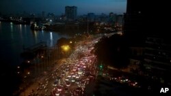 FILE - Traffic moves beside the Saigon River during rush hour in Ho Chi Minh City, Vietnam, Nov. 18, 2015. Senior officials warned at the time that air pollution levels in Ho Chi Minh City and Hanoi alone could soon match the deteriorating air quality of Beijing. A new report says Hanoi's air is now as dirty as Beijing's.