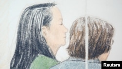 FILE - Huawei CFO Meng Wanzhou (L), who was arrested on an extradition warrant, appears at her B.C. Supreme Court bail hearing in a drawing in Vancouver, British Columbia, Canada, Dec. 10, 2018. 