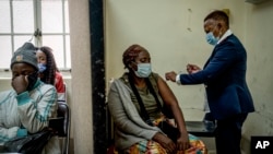 A woman is vaccinated against COVID-19 at the Hillbrow Clinic in Johannesburg, South Africa, Dec. 6, 2021.