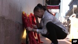 Samantha Petry places flowers at a memorial on Canal and Bourbon Street, Jan. 2, 2025, in New Orleans. 