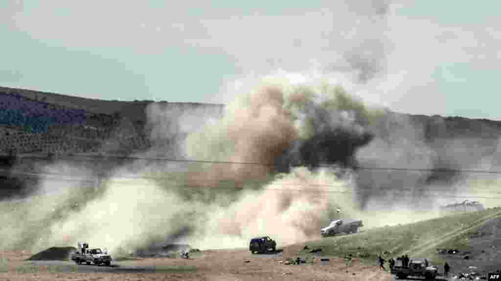 Smoke rises from the Syrian border town of Kobani as Islamic State militants fire mortar shells against Kurdish fighters, as seen from the Turkish border town of Suruc, Nov. 3, 2014. 