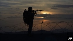FILE - A Pakistani border security guard stands alert at Pakistan-Afghanistan border post, Chaman in Pakistan, May 5, 2017.