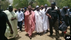 Borno state governor Kashim Shettima, center, visits the secondary school Chibok, were gunmen abducted more than 200 students in Chibok, Nigeria, April, 21. 2014.