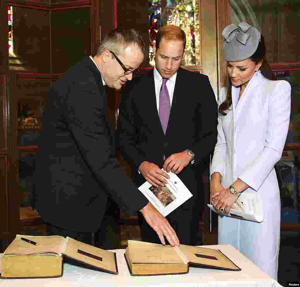 Britain's Prince William and his wife Catherine, Duchess of Cambridge prepare to sign the First Fleet Bible and Prayer Book following Easter Sunday Service at St. Andrews Cathedral in Sydney, April 20, 2014.&nbsp;
