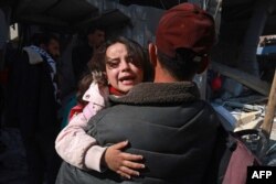 Palestinians flee their homes following Israeli bombardment in Rafah in the southern Gaza Strip on Feb. 24, 2024.