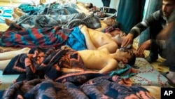 FILE - Victims of a suspected chemical weapons attack lie on the ground in Khan Sheikhoun, in the province of Idlib, Syria, on April 4, 2017. U.N. officials said on March 22, 2024, that after more than 13 years of civil war, the country is even more dangerous for civilians.