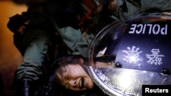 An anti-extradition bill protester is detained by riot police during a protest outside Mong Kok police station, in Hong Kong, China, Sept. 2, 2019.