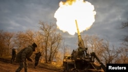 Ukrainian servicemen fire a 2S7 Pion self-propelled gun at a position on a frontline in Kherson region