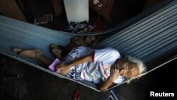Una anciana descansa junto a su nieto en una hamaca en el pueblo de Pimentel, en el estado brasileño de Itaituba.