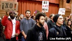 Middlebury College students turn their backs to controversial speaker Charles Murray, unseen, during his talk at the campus in 2017.