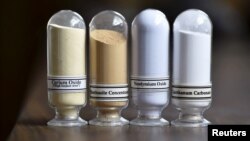 FILE - Samples of rare earth minerals from left, Cerium oxide, Bastnasite, Neodymium oxide and Lanthanum carbonate are on display during a tour of Molycorp's Mountain Pass Rare Earth facility in Mountain Pass, California, June 29, 2015. 