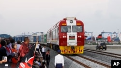 FILE - Kenyans watch the SGR cargo train as it leaves Mombasa for Nairobi, May 30, 2017. The project was a $3.3 billion investment backed by China. Research released in September 2023, however, shows Chinese lending to Africa has fallen sharply. 