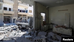 FILE - A general view shows damage at a site hit by airstrikes on Tuesday in the town of Khan Sheikhoun in rebel-held Idlib, April 5, 2017. 