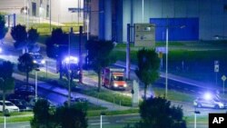 FILE - Police cars accompany an ambulance carrying a man infected with Ebola in Liberia as it leaves the airport in Schkeuditz near Leipzig, eastern Germany, Oct. 9, 2014.
