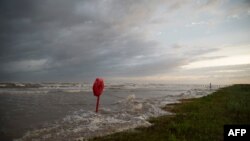 Waves from the storm surge from Hurricane Laura begin to come ashore at Sea Rim State Park on Aug. 26, 2020, in Sabine Pass, Texas.