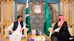 In this photo released by the state-run Saudi Press Agency, Pakistani Prime Minister Imran Khan, left, meets Saudi Crown Prince Mohammed bin Salman, Sept. 19, 2018, in Jiddah, Saudi Arabia. 