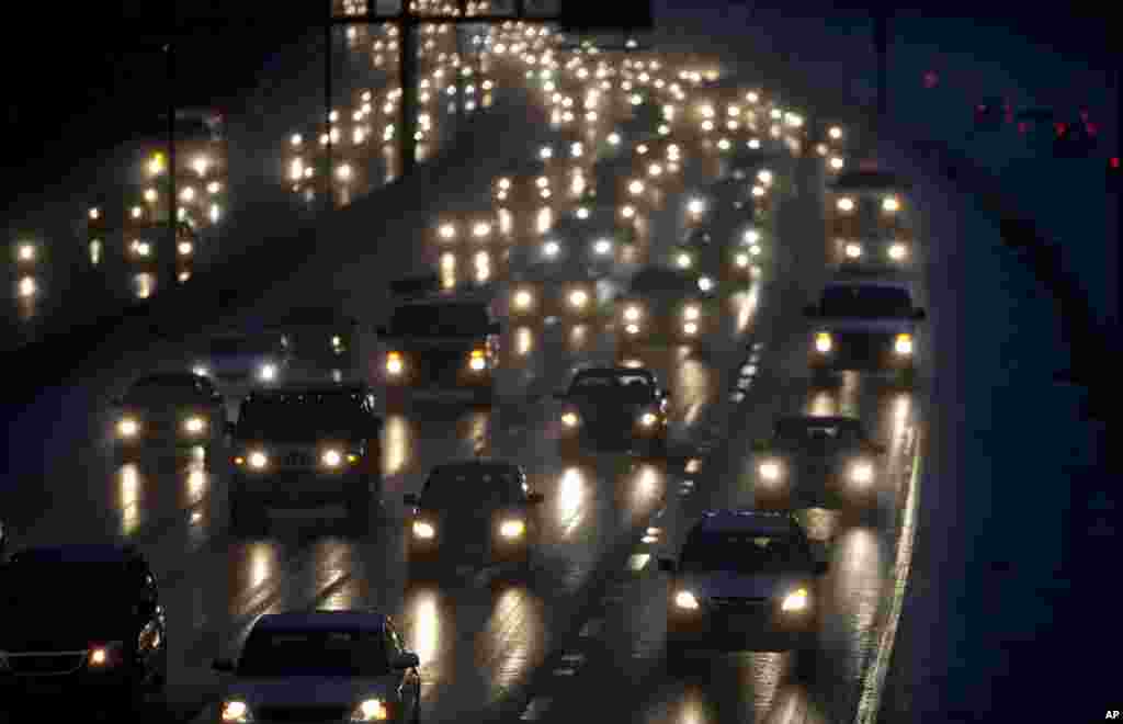 Motorists drive north in the rain on Interstate 270 out of Washington ahead of Thanksgiving, Nov. 26, 2013.