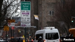 Vehicles pass a sign on 9th Avenue announcing New York City's congestion pricing program in effect charging drivers for entering the central business district in Manhattan below 60th street in New York City, Jan. 6, 2025. 