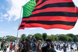 People attend the March on Washington, Aug. 28, 2020, at the Lincoln Memorial in Washington, on the 57th anniversary of the Rev. Martin Luther King Jr.'s "I Have A Dream" speech.