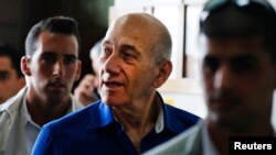 FILE - Former Israeli Prime Minister Ehud Olmert (C) leaves Tel Aviv District Court.