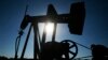 An oil well pumps under the summer sun in a field near Rantoul, Kan., Friday, July 1, 2011. (AP Photo/Orlin Wagner)