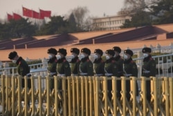 Paramilitary officers wearing masks line up in front of the Tiananmen Gate, as China is hit by an epidemic of the new coronavirus, in Beijing, Jan. 30, 2020.