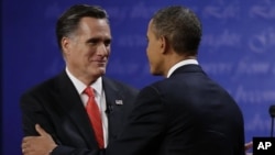 Republican presidential nominee Mitt Romney (L) shakes hands with President Barack Obama following the first presidential debate at the University of Denver, October 3, 2012, in Denver.