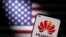 Smartphone with a Huawei logo is seen in front of U.S. flag in this illustration. (Dado Ruvic/Reuters)