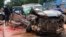 In this photo provided by Cambodia National Police, Cambodia's Prince Norodom Ranariddh's mangled car sits on the side of a road after a collision with another vehicle outside Sihanoukville, Cambodia, Sunday, June 17, 2018. Ranariddh has been seriously injured in the road crash that killed his wife and injured at least seven other people early Sunday. (Cambodia National Police via AP)
